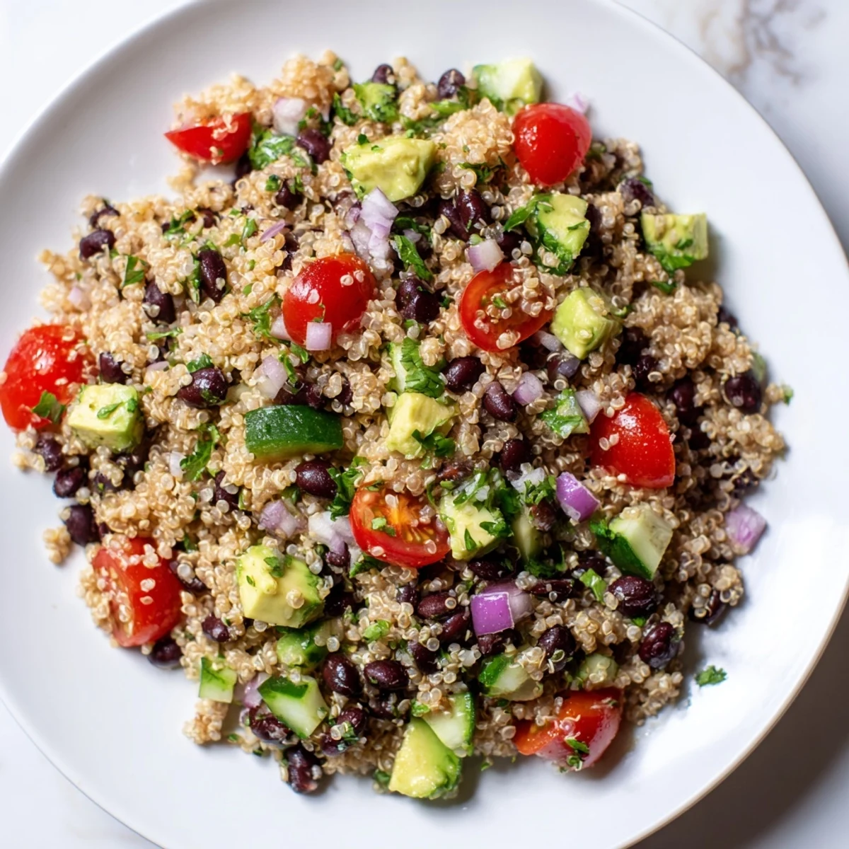 Vibrant quinoa black bean salad, featuring colorful veggies and a zesty lime dressing, ready to enjoy.