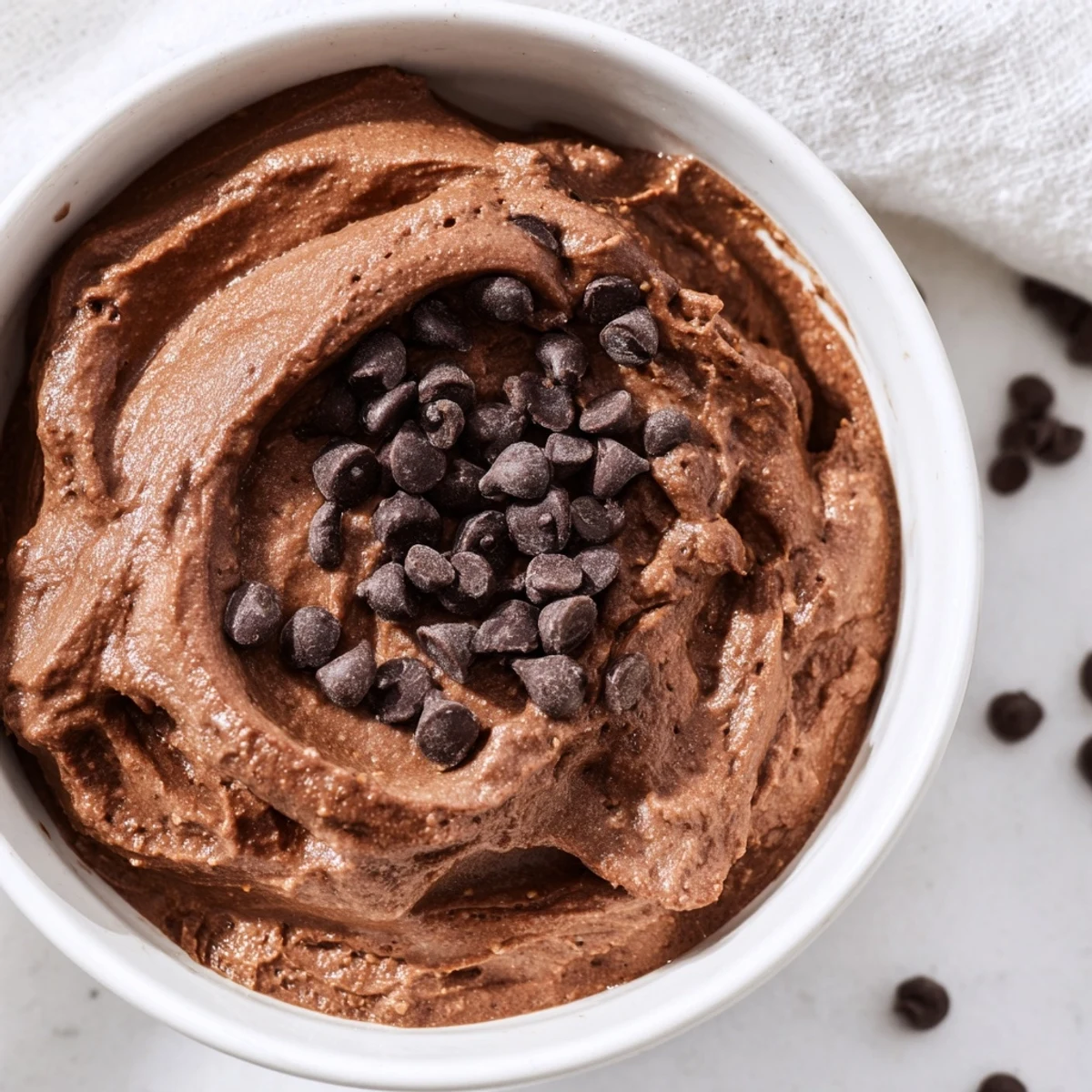 Delicious homemade brownie batter dip, boasting visible mini chocolate chips, ready to share and enjoy.