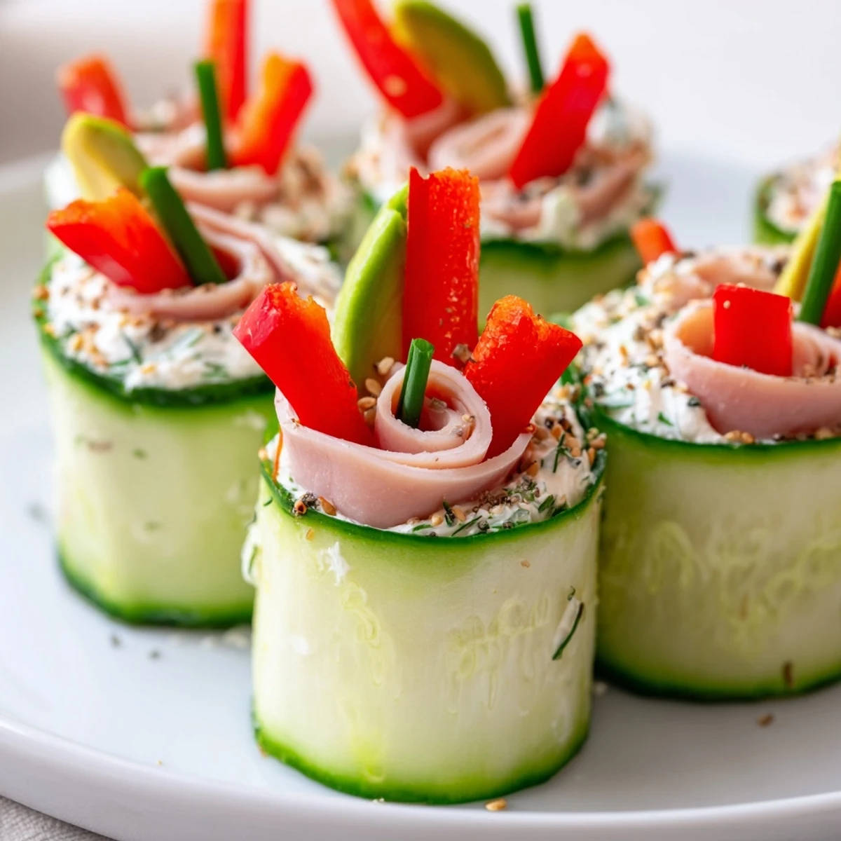 Fresh cucumber roll-ups, filled with cream cheese and deli meat, are perfect for a light snack.