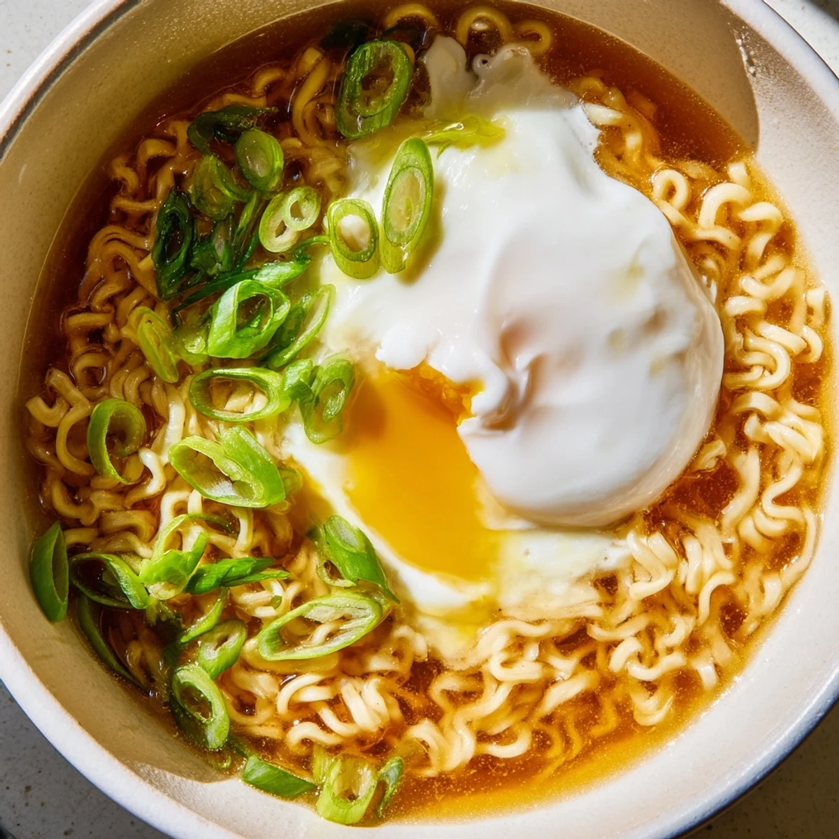 Upgraded instant ramen with a perfectly cooked egg, showing steam rising from a flavorful bowl.