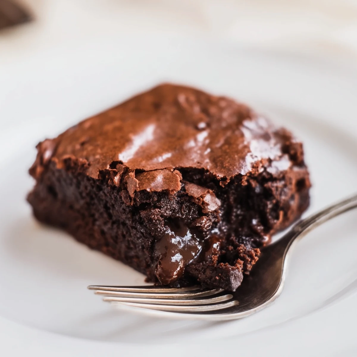 Warm Ina Garten Brownie Pudding, a decadent dessert with a crackly top and gooey, chocolatey center.