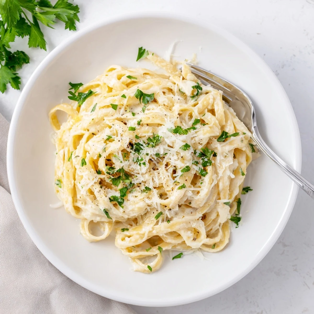 Golden roasted cauliflower florets blend with garlic and Parmesan to create this lighter Alfredo pasta, served steaming and ready to enjoy.
