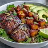 Sliced smoky steak and creamy avocado crown this hearty butternut squash steak bowl, garnished with red onion and toasted pepitas.