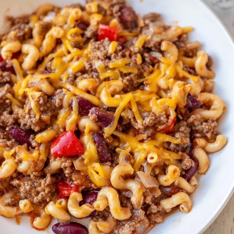 A close-up shot of rich, savory one-pot chili mac, showcasing tender pasta and hearty beef.