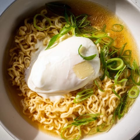 This bowl of upgraded instant ramen features a runny yolk atop the savory noodles and broth.
