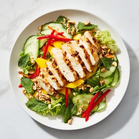 Fresh Thai Mango Chicken Salad, dressed with lime-chili, with a colorful mix of veggies.