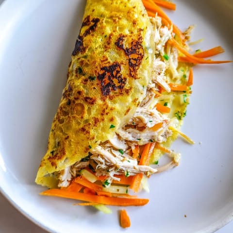 Golden-brown Garlicky Pulled Chicken Wraps, crispy on the outside and filled with vibrant green lettuce and fresh veggies.