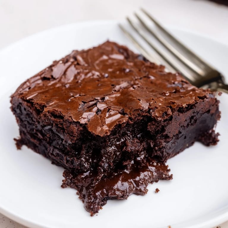 Indulge in a rich, warm serving of Ina Garten Brownie Pudding, perfect for a cozy chocolate craving.